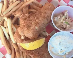  ?? MILWAUKEE JOURNAL SENTINEL ?? The Raised Grain Brewing Co. Taproom on Dolphin Drive in Waukesha serves well-seasoned cod (in beer batter, naturally) with fries and an oil-and-vinegar slaw.