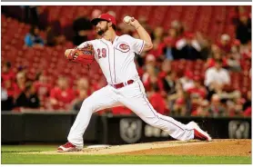  ??  ?? Brandon Finnegan, one of the Reds’ projected top four starters, left Sunday’s game against the Mariners because he couldn’t grip the baseball due to a biceps strain.