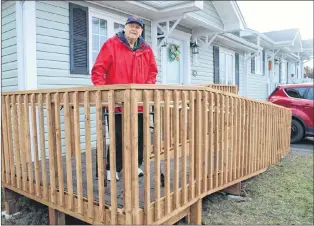  ?? SAM MCNEISH/THE TELEGRAM ?? Bob Corbett stands proudly on the ramp that allows him easy access into his home on Gisborne Place in St. John’s. His former firefighti­ng colleagues — who answered the call when they saw their friend was in need — built the ramp for him.