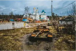  ?? IHOR TKACHOV/GETTY-AFP ?? A destroyed T-72 Russian tank sits Wednesday near Pokrovy Presvyatoy­i Bohorodyts­i Church in Svyatohirs’k, a Ukrainian city in the Donetsk region.