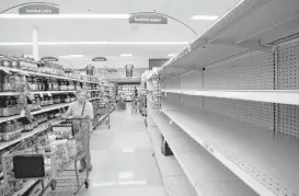  ?? Godofredo A. Vasquez / Houston Chronicle ?? Consumers found empty shelves Thursday in the bottled water section at the Kroger on Buffalo Speedway. The store is expecting truckloads of water today before Harvey reaches landfall.