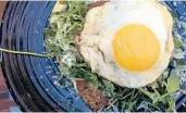  ?? LAUREN DELGADO/STAFF ?? Garp &amp; Fuss’ The Schnitz tops a perfectly crisp chicken schnitzel with Parmesan cheese, arugula and a fried egg.