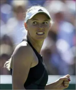  ?? STEVEN PASTON — PA VIA AP ?? Caroline Wozniacki celebrates defeating Angelique Kerber in their semifinal at Eastbourne on Friday.