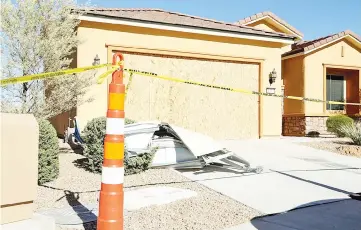  ??  ?? Remains of the garage door sit in the driveway in front of the house in the Sun City Mesquite community where suspected Las Vegas gunman Stephen Paddock lived in Mesquite, Nevada. — AFP photo