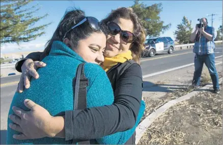  ?? Paul Kitagaki Jr.
Sacramento Bee ?? STUDENT Karen Bustamante, 18, hugs her mother, Gloria Bustamante of San Leandro, Calif., as she leaves the UC Merced campus. The young woman was on the rural campus when an attacker with a knife stabbed four people and then was fatally shot by police.