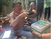  ?? COURTESY PHOTO ?? Always on the job, our columnist photograph­s the cake at his 60th birthday party, notebook near at hand.