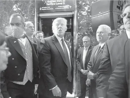  ?? Carolyn Cole Los Angeles Times ?? DONALD TRUMP appears with Vice President-elect Mike Pence at Trump Tower in New York after the president-elect’s news conference, at which he praised Russia for denouncing a report that it had gathered blackmail material against him as “pulp fiction.”