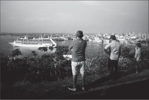  ?? The Associated Press ?? CRUISING: In this May 2, 2016, file photo, people watch the Carnival Adonia cruise ship arrive from Miami in Havana, Cuba.