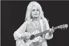  ?? Leon Neal / AFP | Getty Images ?? The Museum of the Bible’s exhibition includes country music via Dolly Parton’s song about a logging preacher.