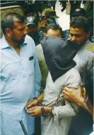  ??  ?? Policemen escort Shafqat Ali (face covered), one of two suspects in the gang-rape case, as they leave from a local court in Lahore yesterday.