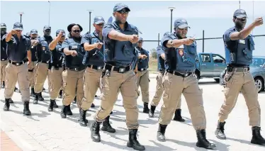  ?? Picture: FREDLIN ADRIAAN ?? CRIMINALS BEWARE: Metro police officers step out during the official opening of the new satellite office in Motherwell. Crime-fighting patrols will be increased over the festive season