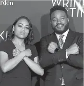  ?? Associated Press ?? ■ Zinzi Evans, left, and Ryan Coogler gesture the "Wakanda Forever" symbol from the film "Black Panther" as they arrive at the world premiere of "A Wrinkle in Time" at the El Capitan Theatre on Monday in Los Angeles.