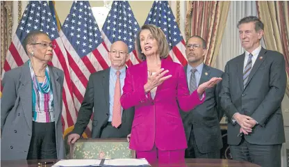  ?? AP ?? Nancy Pelosi talks to reporters on Friday after signing a mandate that requires all government workers to receive retroactiv­e pay after the partial shutdown.