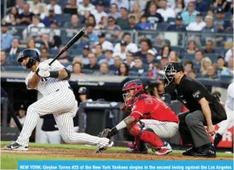  ?? — AFP ?? NEW YORK: Gleyber Torres #25 of the New York Yankees singles in the second inning against the Los Angeles Angels during their game at Yankee Stadium on Sunday in New York City.