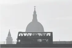  ??  ?? A bus carries commuters as it travels over Waterloo Bridge in London. The vast majority of overseas companies that own property in London, including many used by individual­s to help disguise their ownership, are registered in tax havens, according to a...