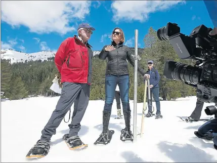  ?? RICH PEDRONCELL­I — THE ASSOCIATED PRESS ?? Karla Nemeth, front right, director of the California Department of Water Resources, and Frank Gehrke, chief of DWR’s California Cooperativ­e Snow Surveys, talk with reporters after conducting a snow survey Monday near Echo Summit.