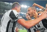  ?? AFP ?? Juventus' Croatian forward Mario Mandzukic (L) celebrates with Leonardo Bonucci after beating Monaco.