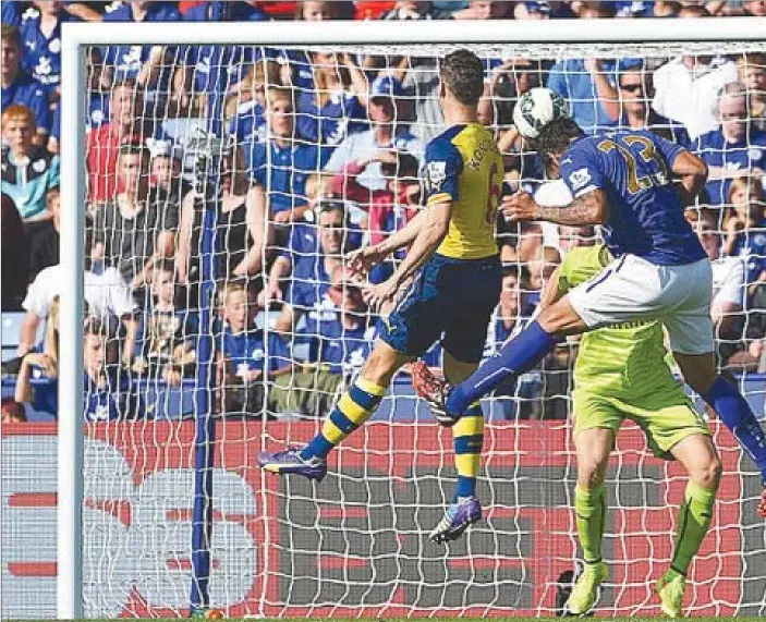  ??  ?? Leonardo Ulloa heads in Leicester's equaliser against Arsenal during their first meeting