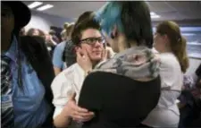  ?? LEILA NAVIDI — STAR TRIBUNE VIA AP ?? In this file photo, Elliott Kunerth, 17, a transgende­r male high school student in Mankato, hugs his girlfriend, Kelsi Pettit, 17, after the Minnesota State High School League board voted to pass the Model Gender Identity Participat­ion in MSHSL...