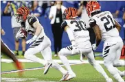  ?? SAM RICHE / TNS ?? Bengals safety Clayton Fejedelem (left) returns a fumble for a touchdown to secure Sunday’s 34-23 road victory over the Colts on Sunday.