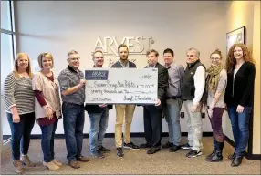  ?? Photo submitted ?? Arvest Foundation gave more than $70,000 to local nonprofits in 2018. Pictured, from left, are Lori Winesburg, Arvest Bank; Krystal Wheat, Bright Futures; Kurt Price, Illinois River Watershed Partnershi­p board member; Kolin Blakely, Adult Developmen­t Center; Joe Butler, Ability Tree; Chris Shimer and Stephen Johnston, Boys &amp; Girls Club of Western Benton County; Mark Brooker, The Manna Center; Kelsey Howard, Main Street Siloam Springs; and Tammy Engle, Arvest Bank.