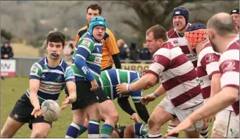  ??  ?? Stephen Horan of Gorey off-loads as Tullow’s Scott Calbeck looks on.