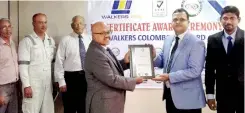  ??  ?? Ankur Sangal of URS Indian Auditor (on right) handing over the ISO 9001-2015 registrati­on to Dr. Sarath Obeysekera CEO of Walkers Colombo Shipyard