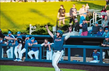  ?? PHOTO COURTESY OF UCONN ATHLETIC DEPARTMENT ?? UConn’s David Smith celebrates after scoring the winning run in the 11th inning that gave the No. 9 Huskies’ a 3-2 Big East victory over Seton Hall on Satuday at Elliot Ball Park in Storrs.