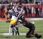  ?? RICK BOWMER — THE ASSOCIATED PRESS ?? Utah's Cole Bishop tackles USC wide receiver Jordan Addison, who had seven catches for 106 yards and a TD.