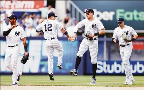  ?? Sarah Stier / Getty Images ?? The Yankees’ Aaron Hicks, Isiah Kiner-Falefa, Aaron Judge, and Joey Gallo celebrate during the ninth inning against the Detroit Tigers at Yankee Stadium on Saturday. The Yankees won 3-0.