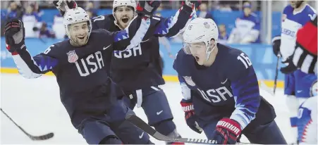  ?? AP PHOTO ?? TWICE AS NICE: Harvard’s Ryan Donato celebrates with teammates after scoring the first of his two goals for Team USA in last night’s 2-1 victory against Slovakia; Ryan Zapolski (right, top) made 21 saves to backbone the victory while Chris Bourque...