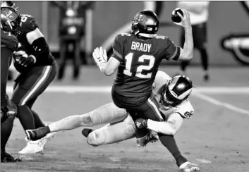  ?? AP Photo/Jason Behnken ?? Los Angeles Rams outside linebacker Samson Ebukam (50) sacks Tampa Bay Buccaneers quarterbac­k Tom Brady (12) during the second half of an NFL football game on Monday in Tampa, Fla.