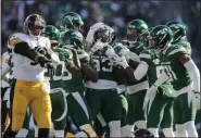  ?? ADAM HUNGER - THE ASSOCIATED PRESS ?? New York Jets linebacker Tarell Basham (93) celebrates an intercepti­on with teammates in the first half of a game against the Pittsburgh Steelers, Sunday, Dec. 22, 2019, in East Rutherford, N.J.