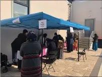  ?? PHOTO COURTESY MOHAMMED HAQUE/NORTH PENN MOSQUE/FACEBOOK ?? People stand socially distanced as they wait to check in to a COVID-19vaccinat­ion clinic on April 4at the North Penn Mosque in Lansdale.