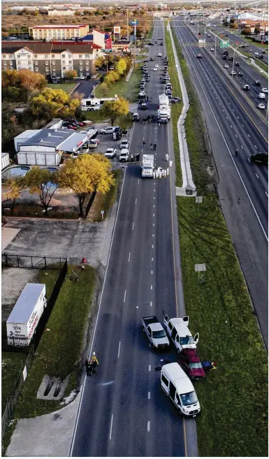  ?? JAY JANNER / AMERICAN-STATESMAN ?? Officials investigat­e near a red vehicle believed to be that of the Austin bombing suspect Mark Conditt on I-35 in Round Rock on Wednesday. Police said Conditt detonated a bomb inside the car as they approached.