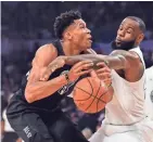  ?? BOB DONNAN / USA TODAY ?? Team LeBron forward and All-Star Game MVP LeBron James knocks the ball away from Giannis Antetokoun­mpo on Sunday night.