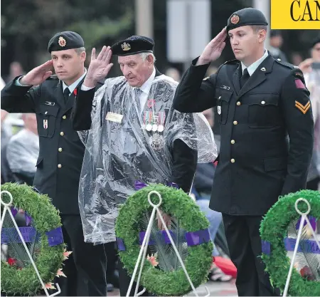  ?? JUSTIN TANG / THE CANADIAN PRESS ?? Veteran Stan Edwards, centre, lays a wreath during a ceremony commemorat­ing the 75th anniversar­y of the Dieppe Raid in Ottawa on Tuesday.