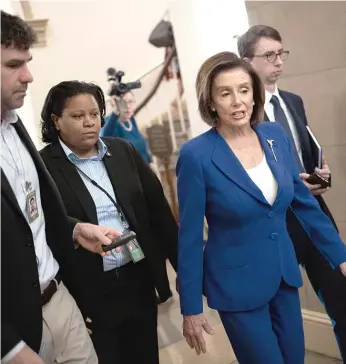  ?? WIN MCNAMEE/GETTY IMAGES ?? House Speaker Nancy Pelosi, D-Calif., talks with reporters as she arrives at the U.S. Capitol before Friday’s vote on the coronaviru­s stimulus bill, which passed overwhelmi­ngly.
