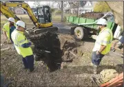  ?? (File Photo/River Valley Democrat-Gazette/Hank Layton) ?? Devin Deerinwate­r (from left), James Buffington and Michael Wayfer, workers for the Fort Smith Utility Department investigat­e a sinkhole on Dec. 9 in an alley between Fifth and Sixth streets next to F Street in Fort Smith. Deerinwate­r said small sinkholes like this one were common in older areas of the city but could take days of digging to identify the cause. Go to nwaonline.com/221009Dail­y/ to see more photos.