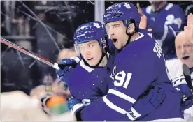  ?? FRANK GUNN THE CANADIAN PRESS ?? Maple Leafs’ John Tavares (91) celebrates his 32nd goal of the season with Mitch Marner against the Ottawa Senators in Toronto on Wednesday. Zach Hyman, Andreas Johnsson, Auston Matthews and Morgan Rielly also scored in a 5-4 victory for Toronto. Magnus Paajarvi, with a pair, Matt Duchene and Thomas Chabot replied for Ottawa. For complete coverage and more NHL news, see thespec.com.