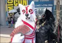  ?? AP PHOTO ?? Christiana Broughton, left, and her mom Carolyn, both of Jacksonvil­le, Fla., dressed as Amaterasu from the video game Okami and a 70’s-era Black Panther, attend the first day of Comic-Con Internatio­nal at the San Diego Convention Center in San Diego,...