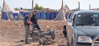  ?? ?? A police officer on Sunday inspects the remnants of a rocket booster that, according to Israeli authoritie­s, critically injured a 7-year-old girl after Iran launched drones and missiles toward Israel.