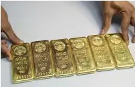  ??  ?? BEDAZZLING BULLION: The original gold bars to be turned into molten metal as the first step in the jewellery-making process.