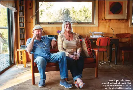  ??  ?? Jazz singer Judy Jacques and partner Sandro Donati in their off-grid, solar-powered home, set amid the bush at Killiecran­kie.