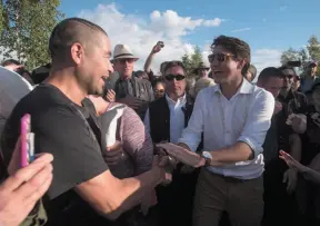  ?? CP PHOTO ?? Prime Minister Justin Trudeau greets people at a Canada Day barbecue in Dawson City, Yukon on Sunday.