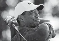  ?? Charlie Riedel / Associated Press ?? Tiger Woods tees off on No. 18 during the third round. Woods finished the second round earlier because of rain Friday.