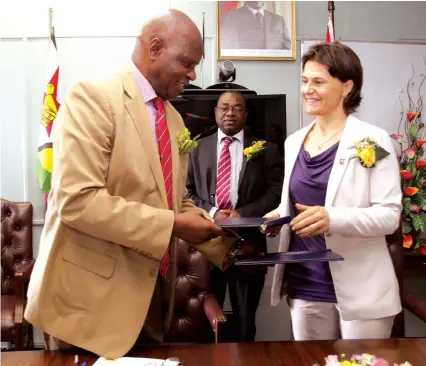  ?? — (Picture by Innocent Makawa) ?? Finance and Economic Developmen­t Minister Patrick Chinamasa and Switzerlan­d Ambassador to Zimbabwe Mrs Ruth Huber (right) exchange signed documents of an agreement on internatio­nal co-operation in Harare yesterday. The agreement will see Switzerlan­d...