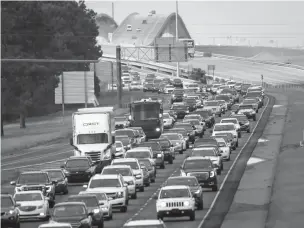  ?? SCOTT THRELKELD/NEW ORLEANS ADVOCATE VIA AP ?? Evacuees heading east Saturday pack Interstate 10 near Slidell, La., as Hurricane Ida approaches. Storm surge warnings stretch from Louisiana’s central coast to the Alabama-Florida border, including Mobile Bay.