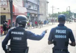  ?? FILE ?? Members of the Jamaica Constabula­ry Force in downtown Kingston following the implementa­tion of a 3 p.m. curfew last April.