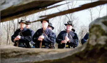  ?? TIMES photograph by Annette Beard ?? A small group of re-enactors showed the crowd, who stood behind the split-rail fence row, what various infantry drills and firing positions were during the Civil War.